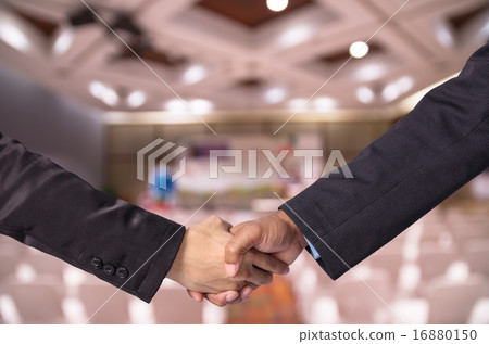 Hand shake between a businessman and a businesswoman o Abstract 16880150