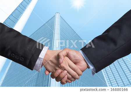 Hand shake between a businessman on Modern glass building backgr 16880166