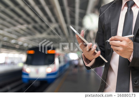 Businessman using the tablet on Abstract blurred photo of sky tr 16880173