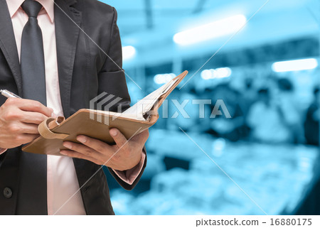 Businessman writing the note book on Abstract blurred photo of b 16880175