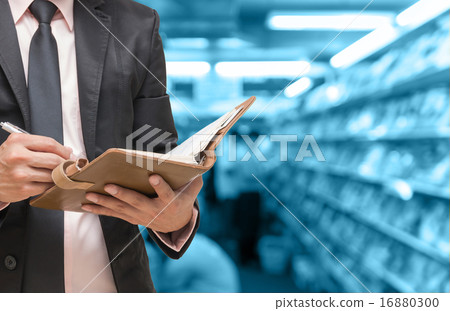Businessman writing the note book on Abstract blurred photo of b 16880300