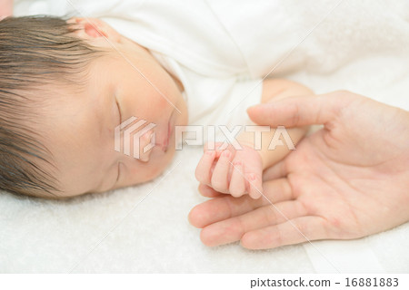 Newborn sleeping wrapped in white spirit 16881883