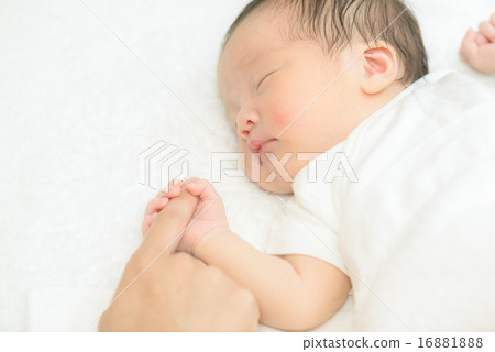 Newborn sleeping wrapped in white spirit 16881888