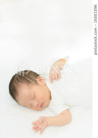 Newborn sleeping wrapped in white spirit 16881896