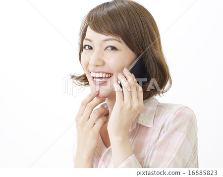 A woman talking on a smartphone 16885823