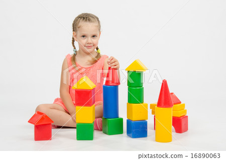 Child cheerfully plays with blocks Child cheerfully plays with blocks 16890063