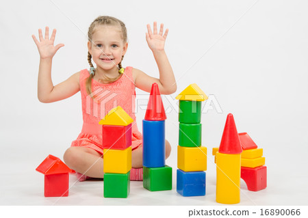 Girl happily raised his hands, playing with blocks Girl happily raised his hands, playing with blocks 16890066