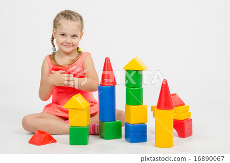 Girl holding two dice and smiles Girl holding two dice and smiles 16890067