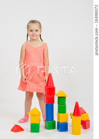 Four-year girl has built a few houses out of blocks Four-year girl has built a few houses out of blocks 16890072