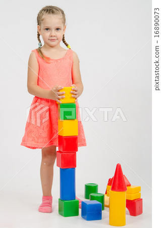 Four-year girl builds a pyramid of cubes Four-year girl builds a pyramid of cubes 16890073