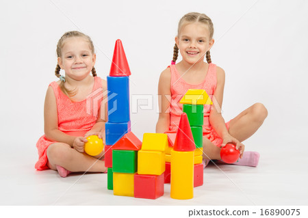 Happy two girls built a castle out of blocks Happy two girls built a castle out of blocks 16890075