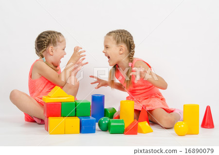 Two girls frighten each other by playing with blocks Two girls frighten each other by playing with blocks 16890079