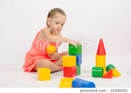 Girl playing in developing a set of dice Girl playing in developing a set of dice 16890082