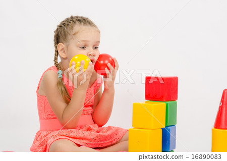Child being played in developing a set of put two balls to the cheeks Child being played in developing a set of put two balls to the cheeks 16890083