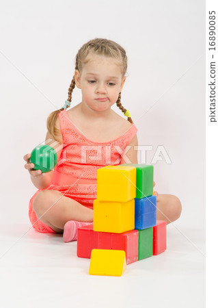 The child does not know where to put ball in house The child does not know where to put ball in house 16890085