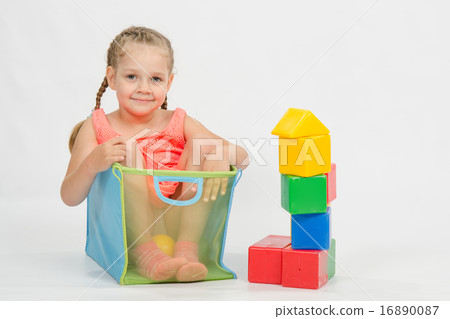The child climbed indulging in a box for toys The child climbed indulging in a box for toys 16890087