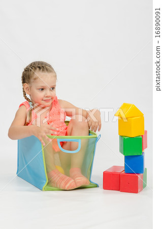 The girl got into box from under blocks The girl got into box from under blocks 16890091