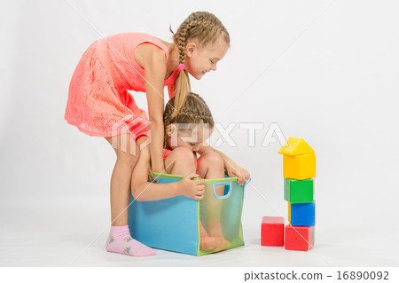 Girl tries to pull another girl out of the box 16890092