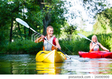 Woman paddling with canoe on forest river 16890900