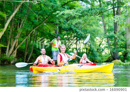 Friends paddling with canoe on forest river Friends paddling with canoe on forest river 16890901