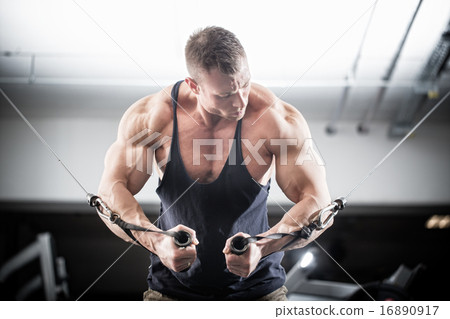 Stock Photo: Bodybuilder doing butterfly on cable pull