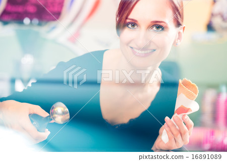 Sales girl portion s scoop of ice cream to wafer Sales girl portion s scoop of ice cream to wafer 16891089