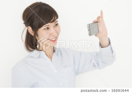 A woman shooting with a cell phone A woman shooting with a cell phone 16891644