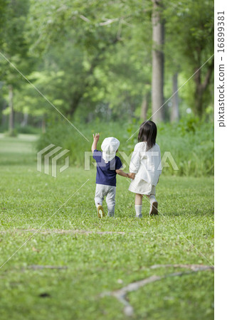 Brothers walking hand in hand 16899381