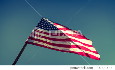 American flag with stars and stripes hold with hands against blu American flag with stars and stripes hold with hands against blu 16900588