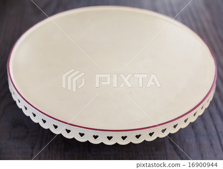 Empty white plate on wooden table Empty white plate on wooden table 16900944