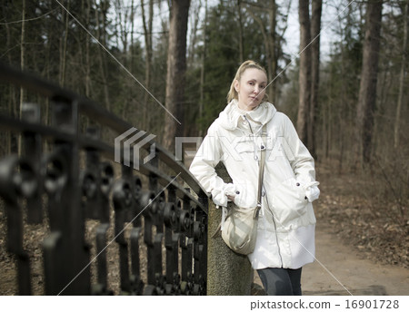 woman near a bridge in park in the early spring woman near a bridge in park in the early spring 16901728