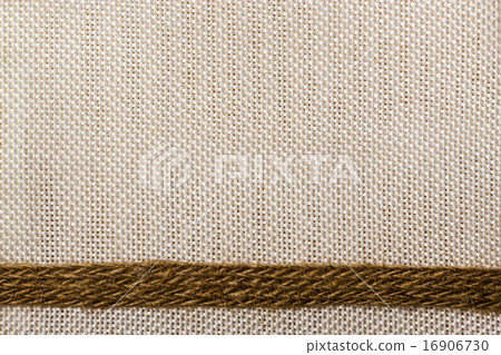 Jute ribbon on sack cloth background Jute ribbon on sack cloth background 16906730