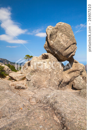 Big round stone lays on top of a mountain Big round stone lays on top of a mountain 16907810