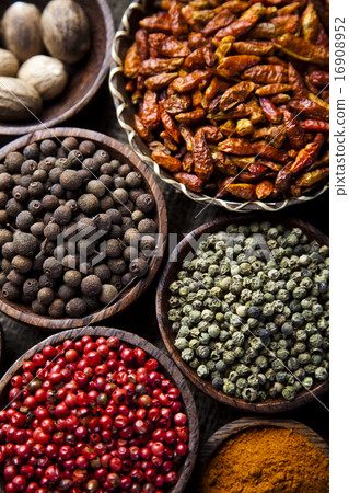 Assortment of spices in wooden bowl background 16908952