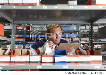 Factory Worker In Store Room Checking Stock 16912408