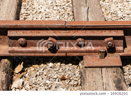 Rusted railway ties linked with bolts 16916201