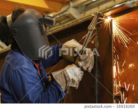 worker using torch cutter to cut through metal 16918260