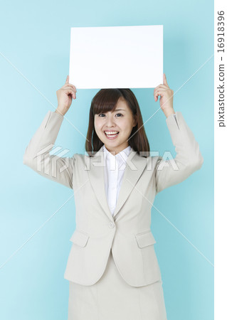A smiling woman with a message board A smiling woman with a message board 16918396