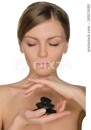 charming woman holding stones in hand charming woman holding stones in hand 16923080