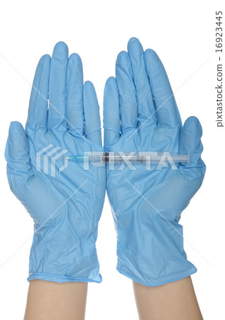 Syringe with on palms in gloves of nurses 16923445