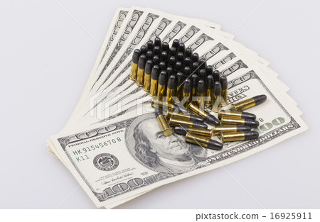 ammunition from the gun on 100 dollar bills 16925911