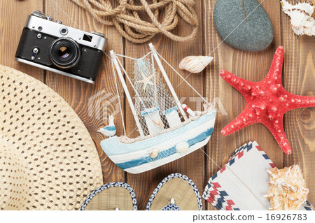 Travel and vacation items on wooden table Travel and vacation items on wooden table 16926783