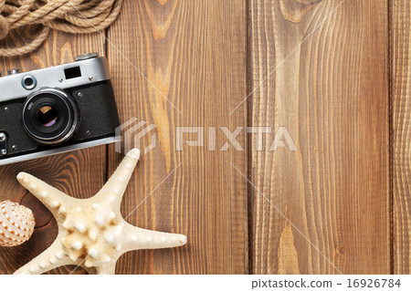 Travel and vacation items on wooden table Travel and vacation items on wooden table 16926784