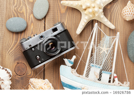 Travel and vacation items on wooden table Travel and vacation items on wooden table 16926786
