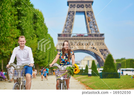 Couple of tourists using bicycles in Paris, France 16932030