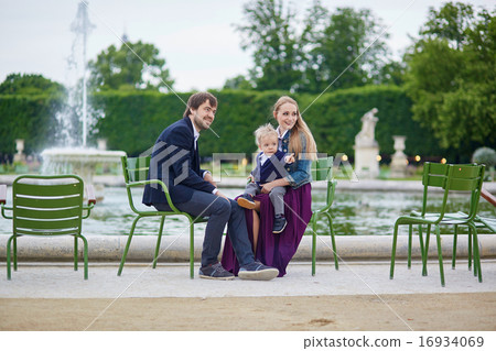 Happy family of three in Paris on a summer day 16934069
