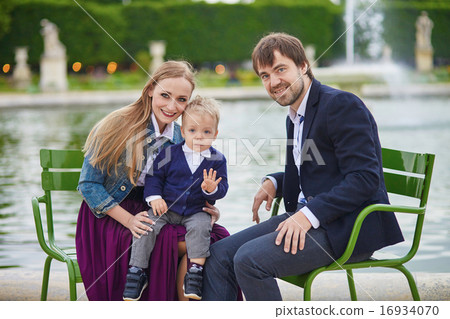Happy family of three in Paris on a summer day 16934070