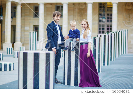 Happy family of three in Palais Royal in Paris Happy family of three in Palais Royal in Paris 16934081