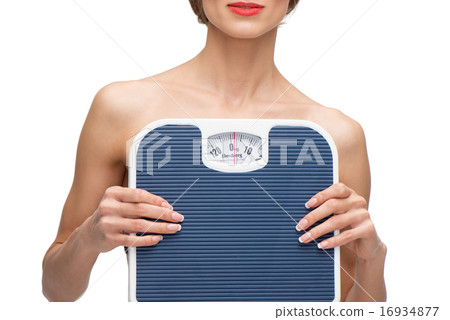 Close up portrait of woman holding weighs Close up portrait of woman holding weighs 16934877