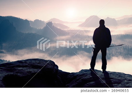 Misty day in rocky mountains Silhouette of tourist 16940655